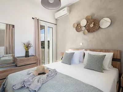 a bedroom with a bed with a hat on it at Villa Kelaidis in Megála Khoráfia