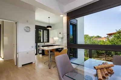 a kitchen and dining room with a glass table at Villa Darazzo with Private Pool in Daratso