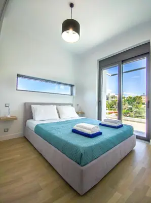 a bedroom with a large bed with a large window at Villa Darazzo with Private Pool in Daratso
