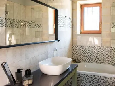 a bathroom with a white sink and a tub at Prinus Country Retreat Apokoronas, heated pool, 13km from the sea in Embrósneros
