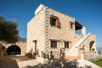 a large brick building with a window and a staircase at Prinus Country Retreat Apokoronas, heated pool, 13km from the sea in Embrósneros