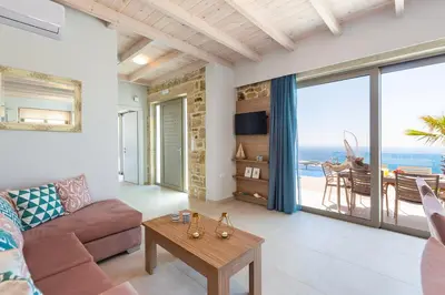 a living room with a couch and a table at Blue Horizon Luxury Villas in Falasarna