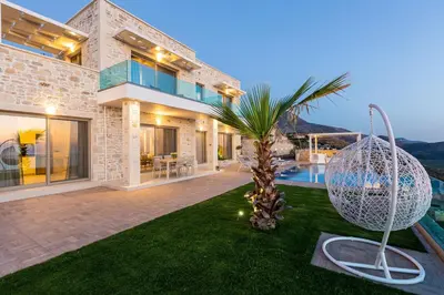 a house with a palm tree in the yard at Blue Horizon Luxury Villas in Falasarna