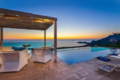 a villa with a swimming pool with a view of the ocean at Blue Horizon Luxury Villas in Falasarna
