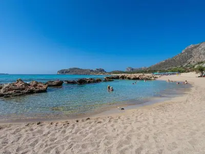 a group of people in the water at a beach at Blue Horizon Luxury Villas in Falasarna