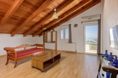 a bedroom with a bed and a table in a room at Villa Konstantinos Hilltop Vineyard Escape in Chania Town
