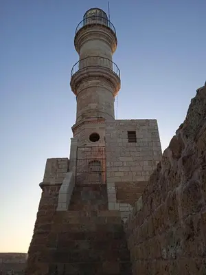 a lighthouse sitting on top of a brick wall at Spartis House 30m from the beach in Chania Town