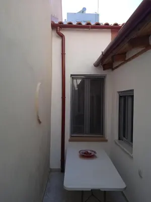 a white table in a room with a window at Spartis House 30m from the beach in Chania Town