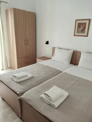 a bedroom with two beds with towels on them at Protopapas in Palaiochóra