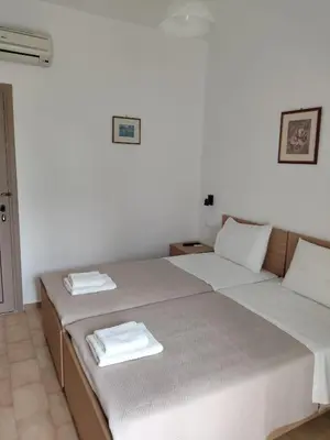 a bedroom with two beds with towels on them at Protopapas in Palaiochóra