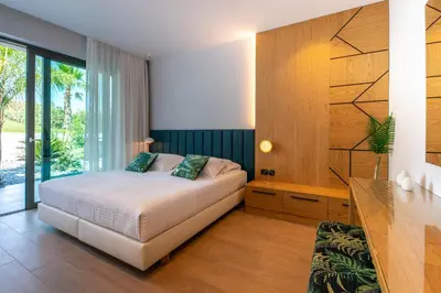 a bedroom with a bed and a large window at Villa Lydia I Superb views, two pools, next to the city in Kissamos