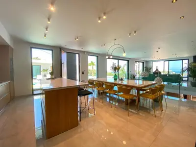 a kitchen and dining room with a table and chairs at Villa Lydia I Superb views, two pools, next to the city in Kissamos