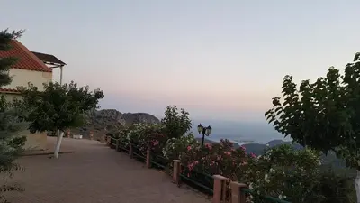 a street with flowers and a fence with a view at Best View Mountain Villa in Teménia