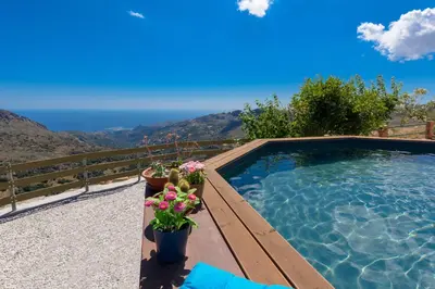 a swimming pool with a view of the ocean at Best View Mountain Villa in Teménia