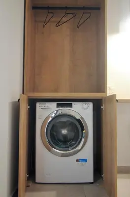 a washing machine with a cabinet on top of it at Antigonis Garden House in Chania Town