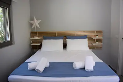 a bedroom with a bed with two white towels on it at Antigonis Garden House in Chania Town