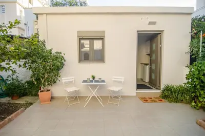 a patio with a table and chairs in front of a house at Antigonis Garden House in Chania Town