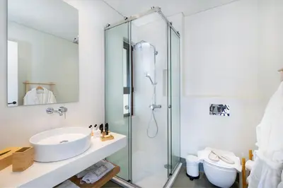a bathroom with a sink and a shower at Kassiopeia Villa in Chania Town