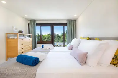 a large white bed with white pillows in a bedroom at Kassiopeia Villa in Chania Town