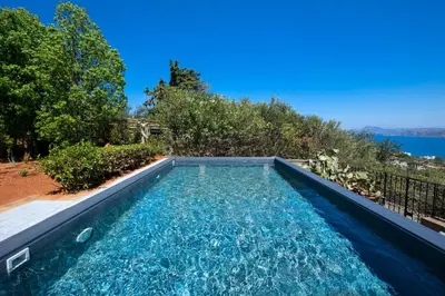 a swimming pool in the backyard of a house at Kassiopeia Villa in Chania Town