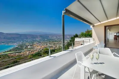 a view from the balcony of a house with a table and chairs at Kassiopeia Villa in Chania Town