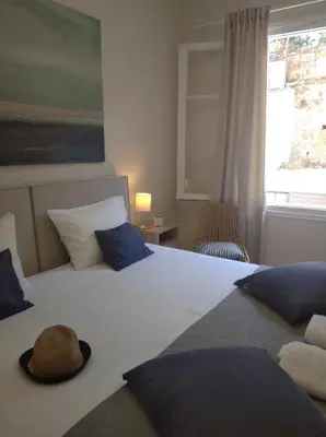 a bedroom with a bed with a hat on it at Marinos Suites in Chania Town