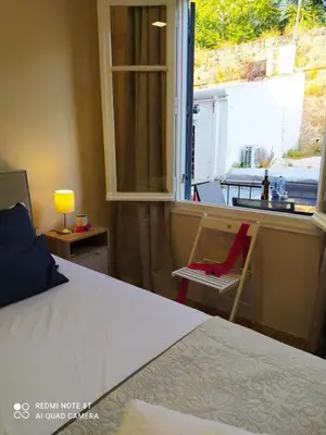 a bedroom with a bed and a window with a sink at Marinos Suites in Chania Town