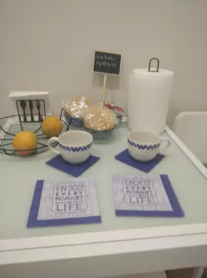 a table with two cups and a sign that reads happy birthday extended life at Marinos Suites in Chania Town