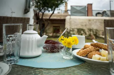a table with a plate of food on a table at Agarathos Deluxe Homes In the Heart of Kaliviani Near Balos in Kissamos
