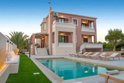 a villa with a swimming pool and a house at Ar & Al Luxury Villa in Galatás