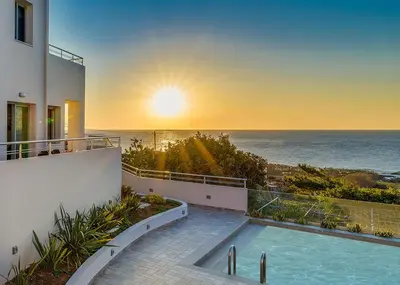 a view of the ocean from the balcony of a house at Sunset Elafonisi Apartments in Livadia