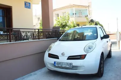 a white car parked in front of a building at Daphne's house Families Only in Chania Town