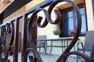 a table and chairs on the balcony of a house at Daphne's house Families Only in Chania Town