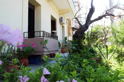 a garden in front of a house with flowers at Daphne's house Families Only in Chania Town
