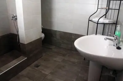 a bathroom with a sink and a shower and a toilet at Daphne's house Families Only in Chania Town