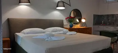 a bedroom with a white bed with towels on it at GIANNIS in Galatás