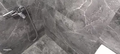 a shower in a bathroom with a marble floor at GIANNIS in Galatás