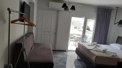 a bedroom with a bed and a sliding glass door at GIANNIS in Galatás