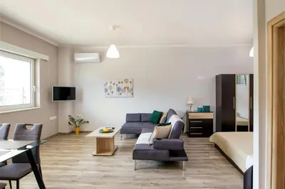 a living room with a couch and a bed at Stellina's new studio 5min from beach in Souda