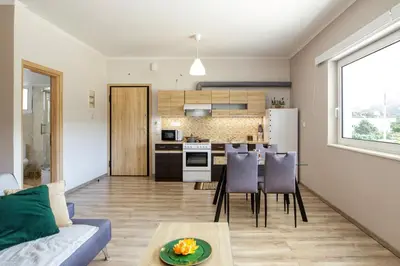 a living room with a couch and a table at Stellina's new studio 5min from beach in Souda