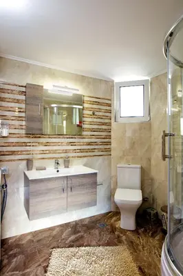 a bathroom with a toilet and a sink and a mirror at Stellina's new studio 5min from beach in Souda