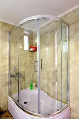 a shower with a glass enclosure in a bathroom at Stellina's new studio 5min from beach in Souda