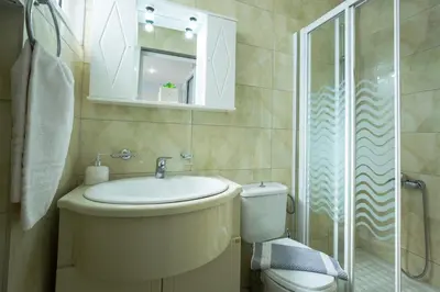 a bathroom with a toilet and a sink and a shower at Aqua Marine in Falasarna