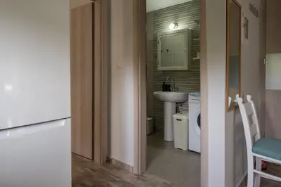 a small bathroom with a sink and a toilet at The Prickly Pear Apartment in Chania Town