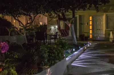 a courtyard with trees and plants in front of a building at The Prickly Pear Apartment in Chania Town