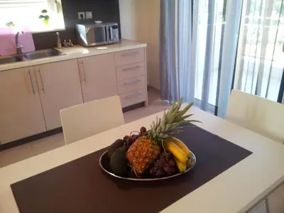 a bowl of fruit on a table in a kitchen at Crete View in Marathi