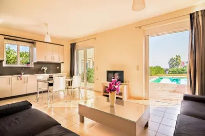 a living room with a couch and a table at Crete View in Marathi