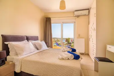 a bedroom with a large bed with a window at Crete View in Marathi