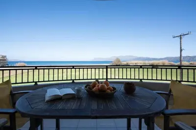 a table with a bowl of fruit and a book at Terpsis House in Kissamos
