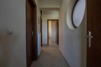 a hallway with a mirror on the wall and a hallwayngthngthngthngthngth at Terpsis House in Kissamos